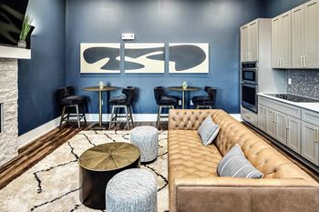 Resident Lounge with Fireplace, Bar, and Kitchen Area at The Fireside at Waukee in Waukee, IA