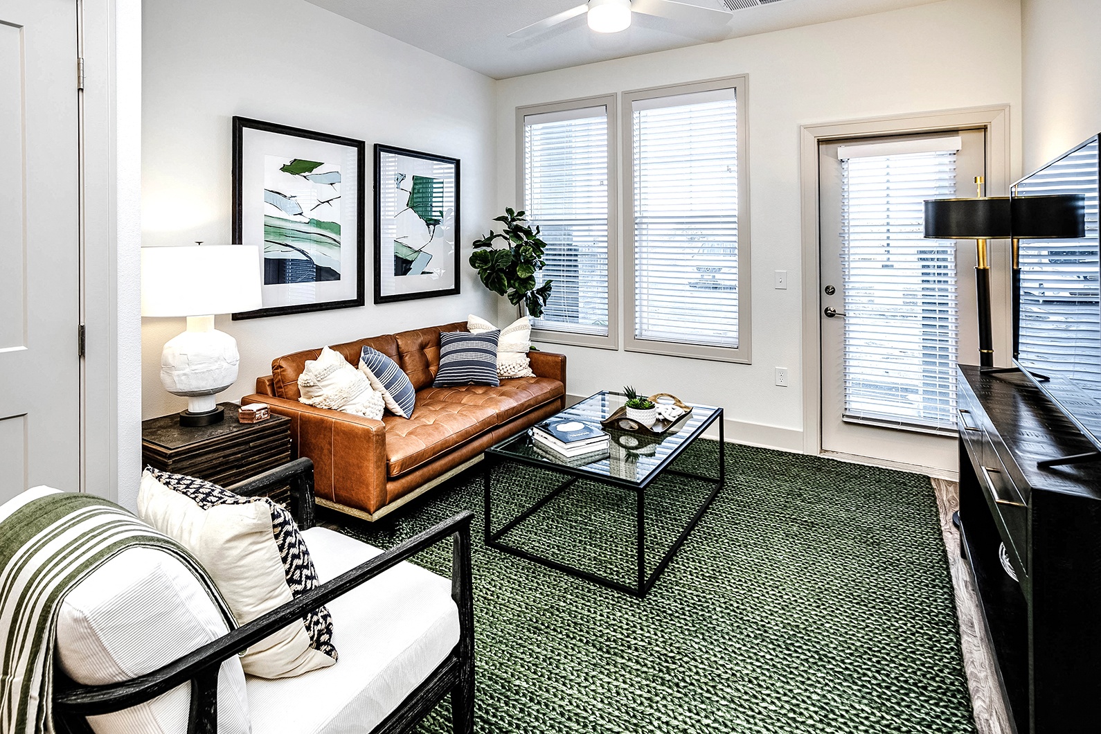 Studio, one, and two-bedroom apartment homes with stainless steel appliances, quarts countertops, designer cabinetry, large kitchens, luxury vinyl plank flooring, high vaulted ceilings, high-end lighting, in-unit washer and dryer, and energy efficient windows at Fireside at Waukee in Waukee, IA