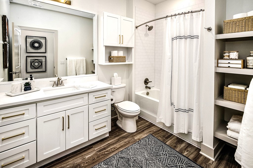 Studio, one, and two-bedroom apartment homes with stainless steel appliances, quarts countertops, designer cabinetry, large kitchens, luxury vinyl plank flooring, high vaulted ceilings, high-end lighting, in-unit washer and dryer, and energy efficient windows at Fireside at Waukee in Waukee, IA