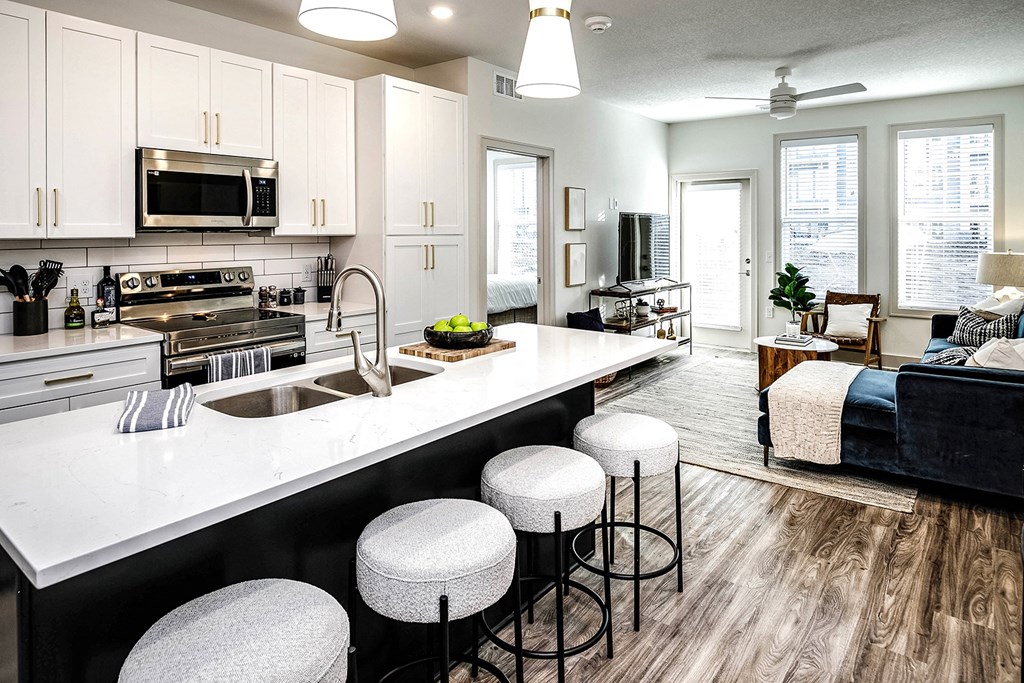Studio, one, and two-bedroom apartment homes with stainless steel appliances, quarts countertops, designer cabinetry, large kitchens, luxury vinyl plank flooring, high vaulted ceilings, high-end lighting, in-unit washer and dryer, and energy efficient windows at Fireside at Waukee in Waukee, IA