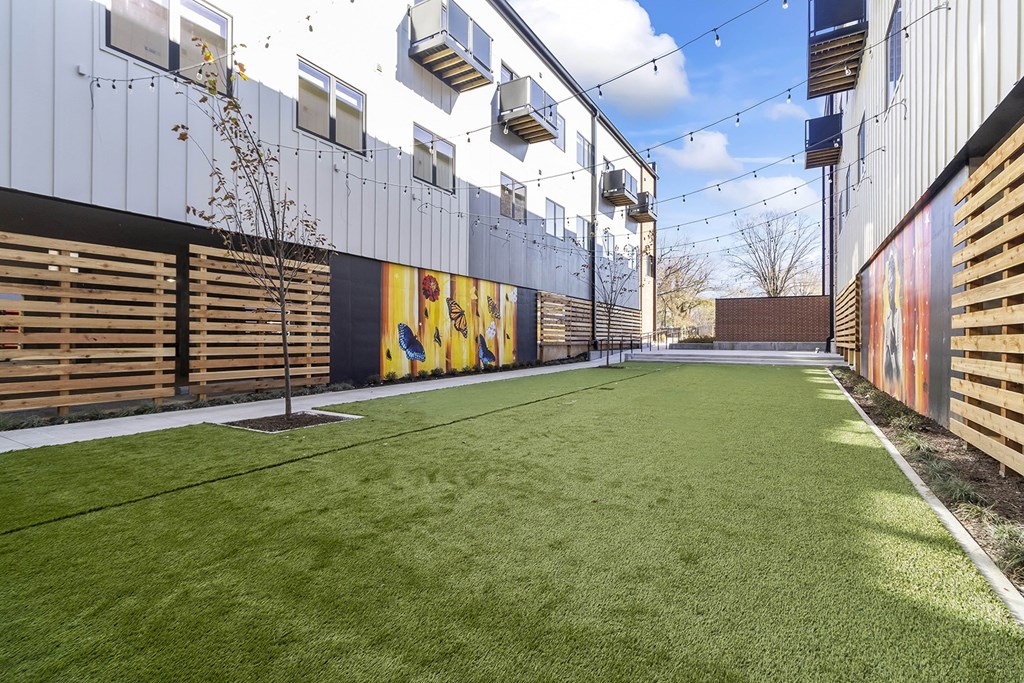 Private Outdoor Courtyard with Yard Games, Grills and Fire Pit at G at Market in Bentonville, AR