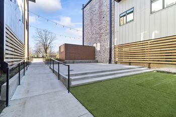 Private Outdoor Courtyard with Yard Games, Grills and Fire Pit at G at Market in Bentonville, AR