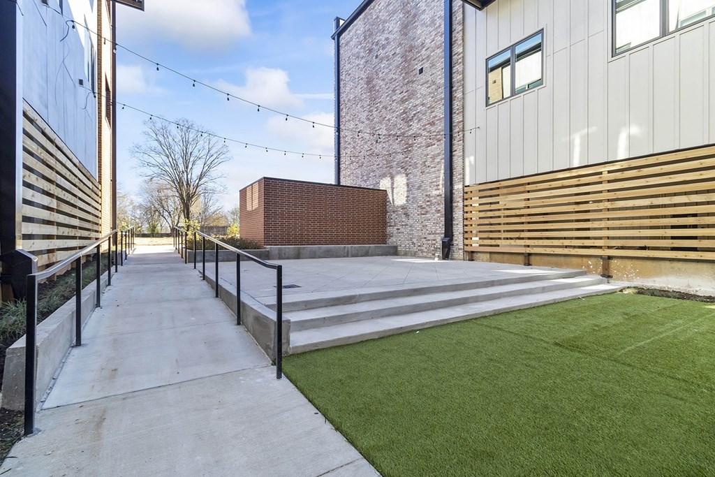 Private Outdoor Courtyard with Yard Games, Grills and Fire Pit at G at Market in Bentonville, AR