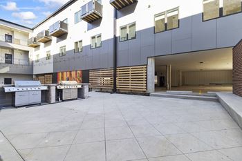 Private Outdoor Courtyard with Yard Games, Grills and Fire Pit at G at Market in Bentonville, AR