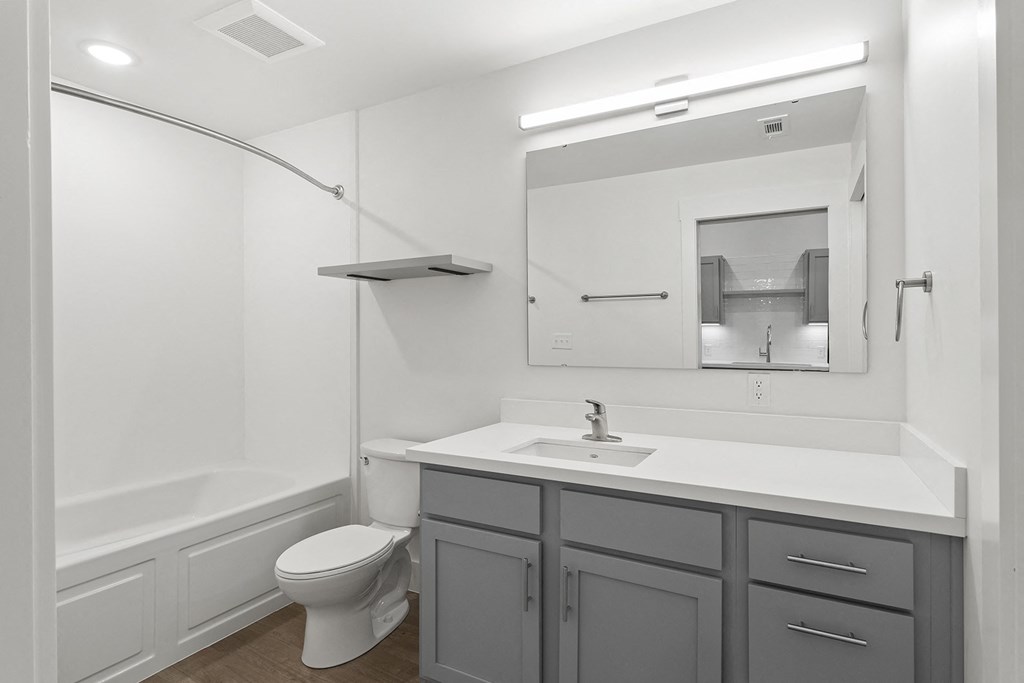 Bathrooms with custom quartz countertops and large soaking tubs at G at Market in Bentonville, AR