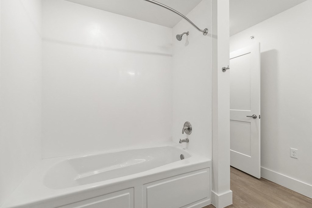 Bathrooms with custom quartz countertops and large soaking tubs at G at Market in Bentonville, AR