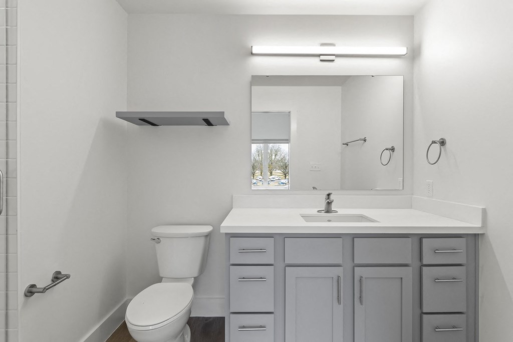 Bathrooms with custom quartz countertops and large soaking tubs at G at Market in Bentonville, AR