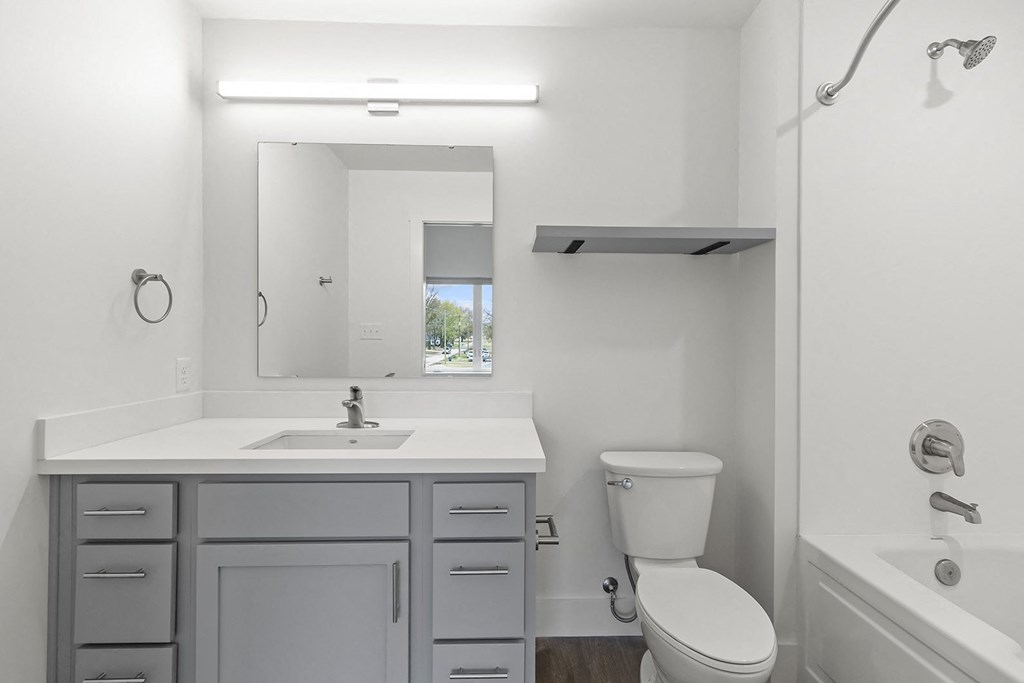 Bathrooms with custom quartz countertops and large soaking tubs at G at Market in Bentonville, AR