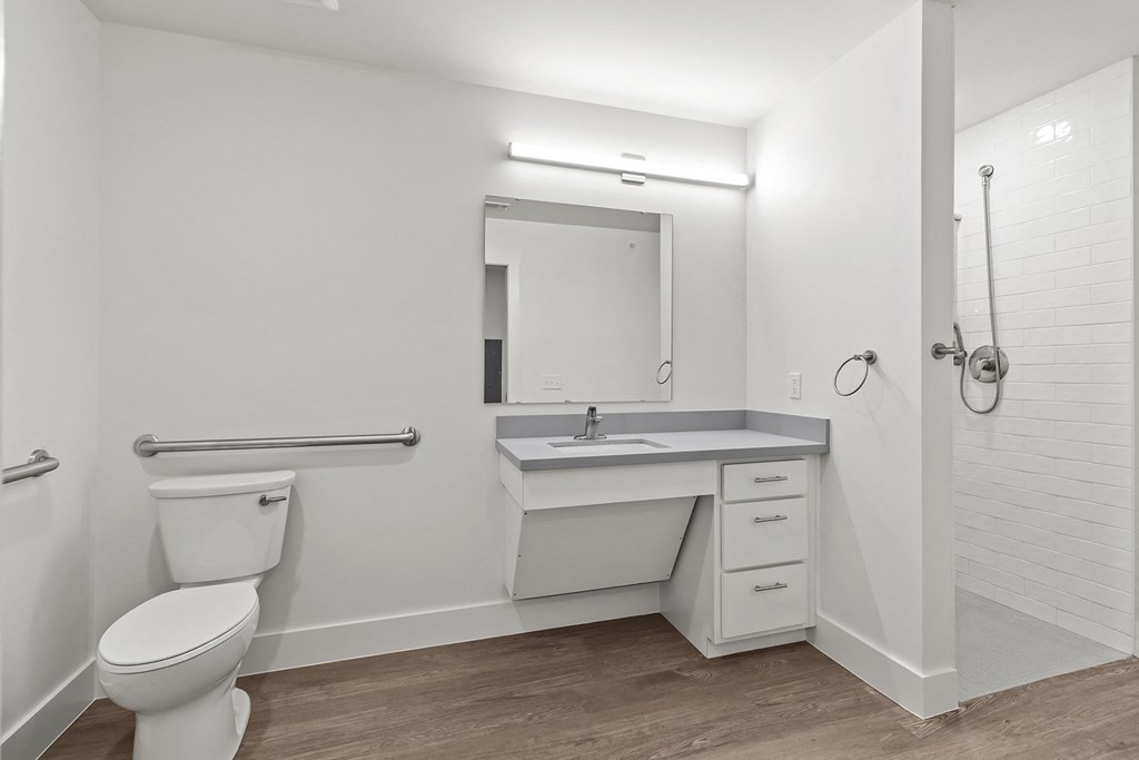 Bathrooms with custom quartz countertops and large soaking tubs at G at Market in Bentonville, AR