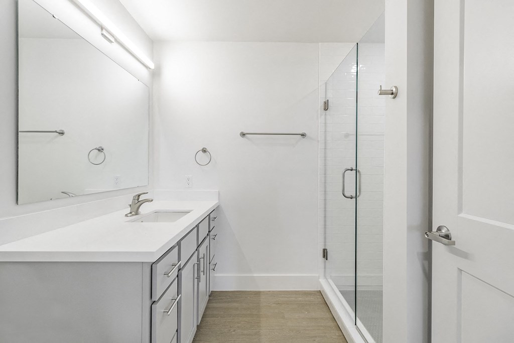 Bathrooms with custom quartz countertops and large soaking tubs at G at Market in Bentonville, AR