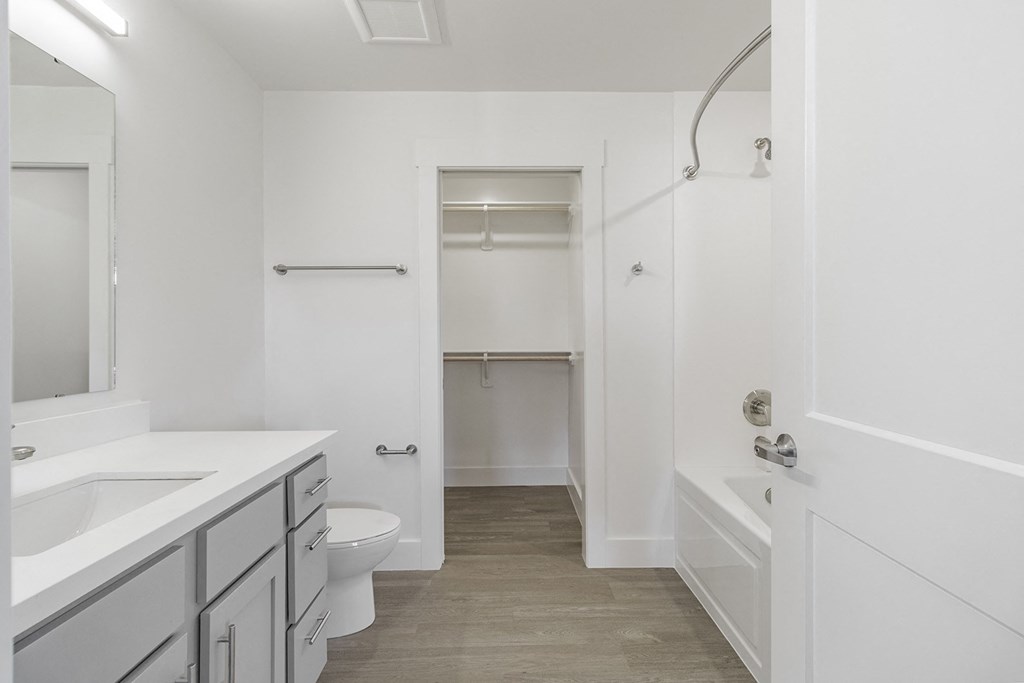 Bathrooms with custom quartz countertops and large soaking tubs at G at Market in Bentonville, AR