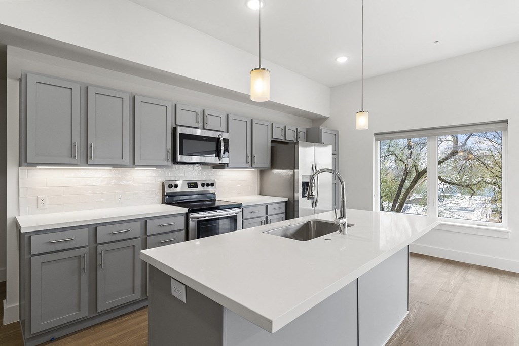 Large open kitchens with custom quartz countertops at G at Market in Bentonville, AR