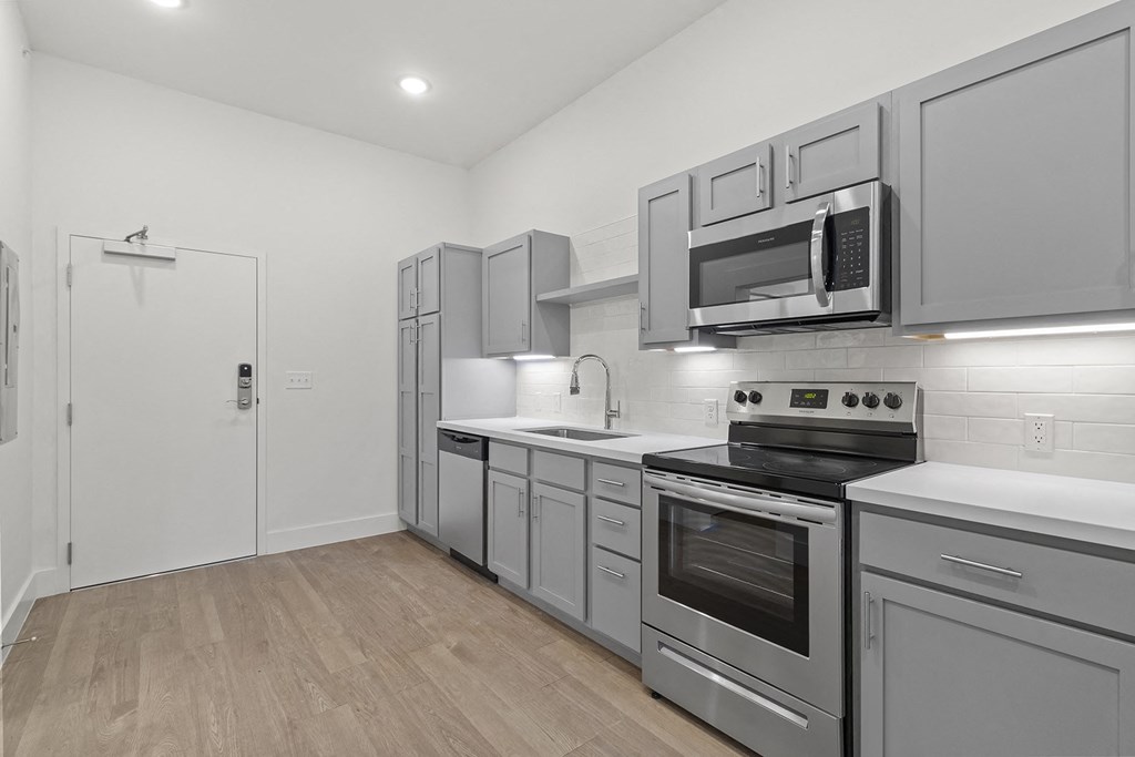 Large open kitchens with custom quartz countertops at G at Market in Bentonville, AR