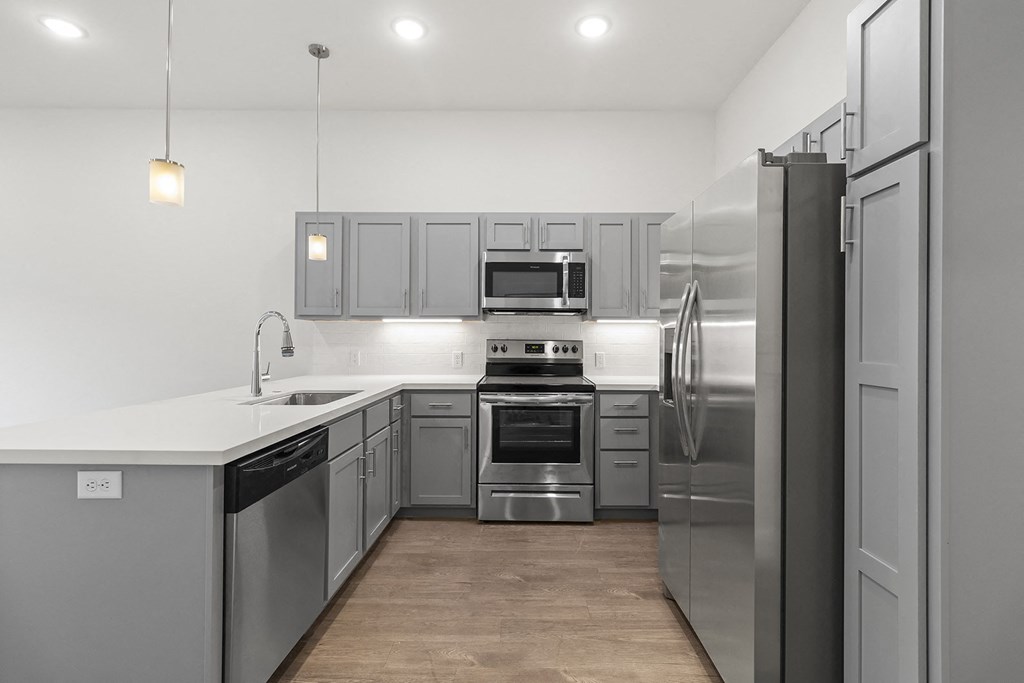 Large open kitchens with custom quartz countertops at G at Market in Bentonville, AR