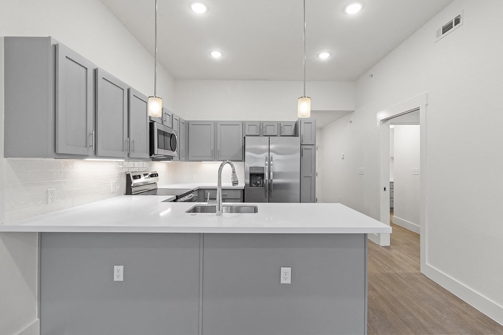 Large open kitchens with custom quartz countertops at G at Market in Bentonville, AR