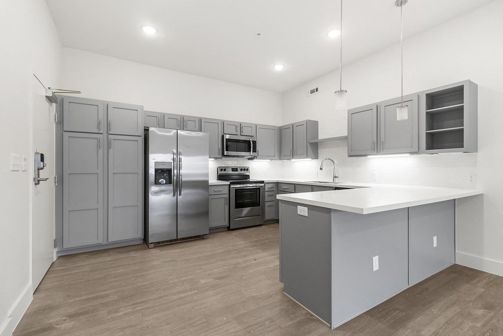 Large open kitchens with custom quartz countertops at G at Market in Bentonville, AR
