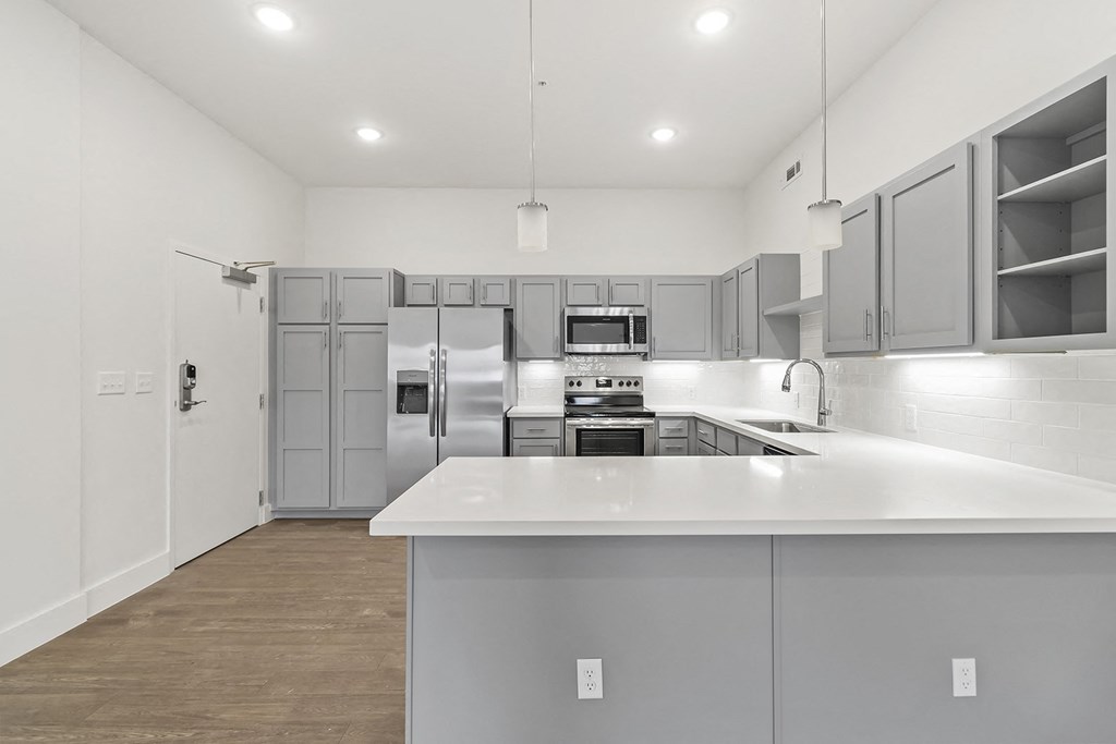 Large open kitchens with custom quartz countertops at G at Market in Bentonville, AR