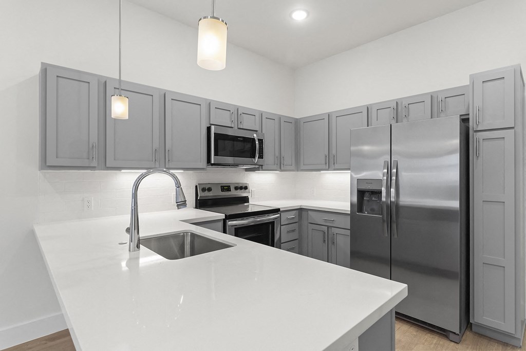 Large open kitchens with custom quartz countertops at G at Market in Bentonville, AR