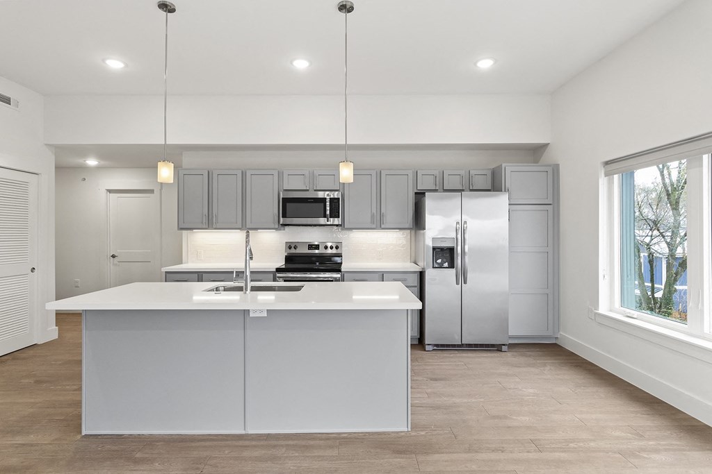 Large open kitchens with custom quartz countertops at G at Market in Bentonville, AR