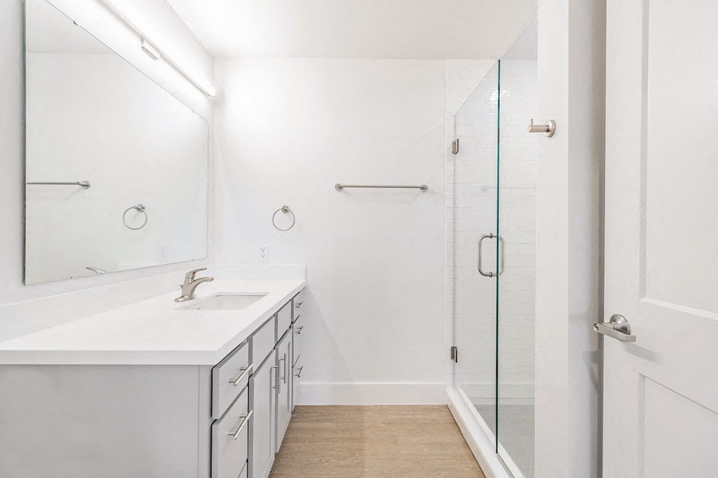 Bathrooms with custom quartz countertops and large soaking tubs at G at Market in Bentonville, AR