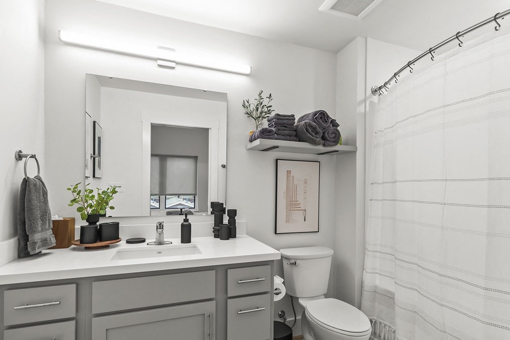 Bathrooms with custom quartz countertops and large soaking tubs at G at Market in Bentonville, AR