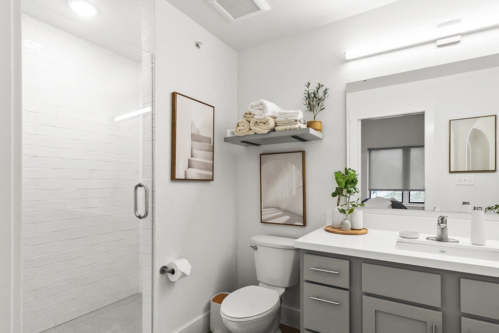 Bathrooms with custom quartz countertops and large soaking tubs at G at Market in Bentonville, AR