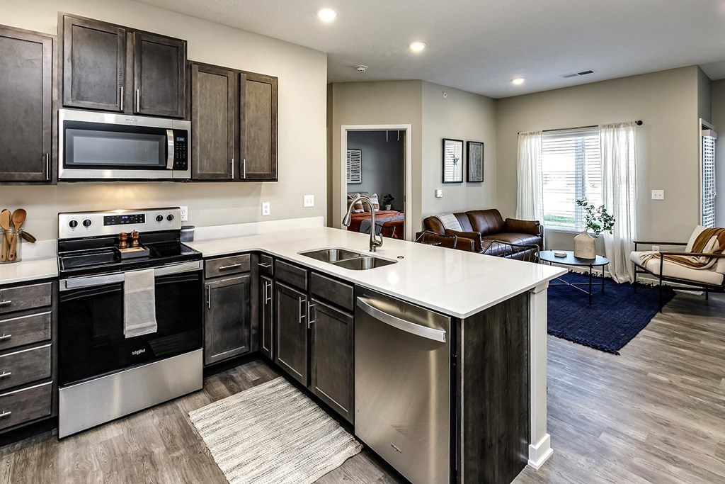 Kitchen with dark cabinets and a white counter tops at Hanover Flats in Bennington, NE