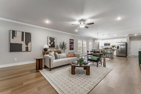 A modern living room with a white couch and a coffee table.