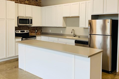 a kitchen with white cabinets and a counter top
