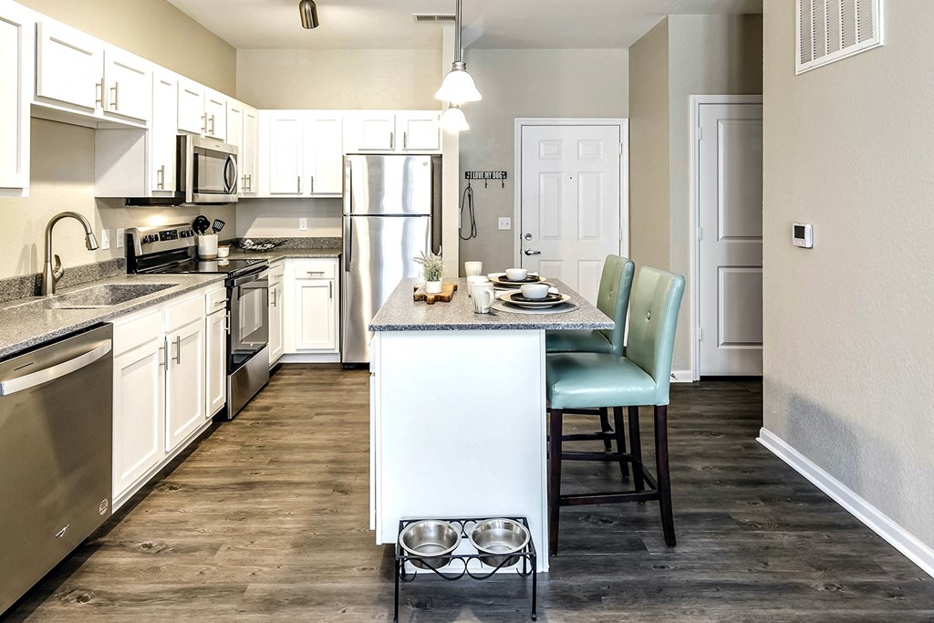 Kitchen with white cabinets and stainless steel appliances at Legacy Commons Apartments in Omaha, NE