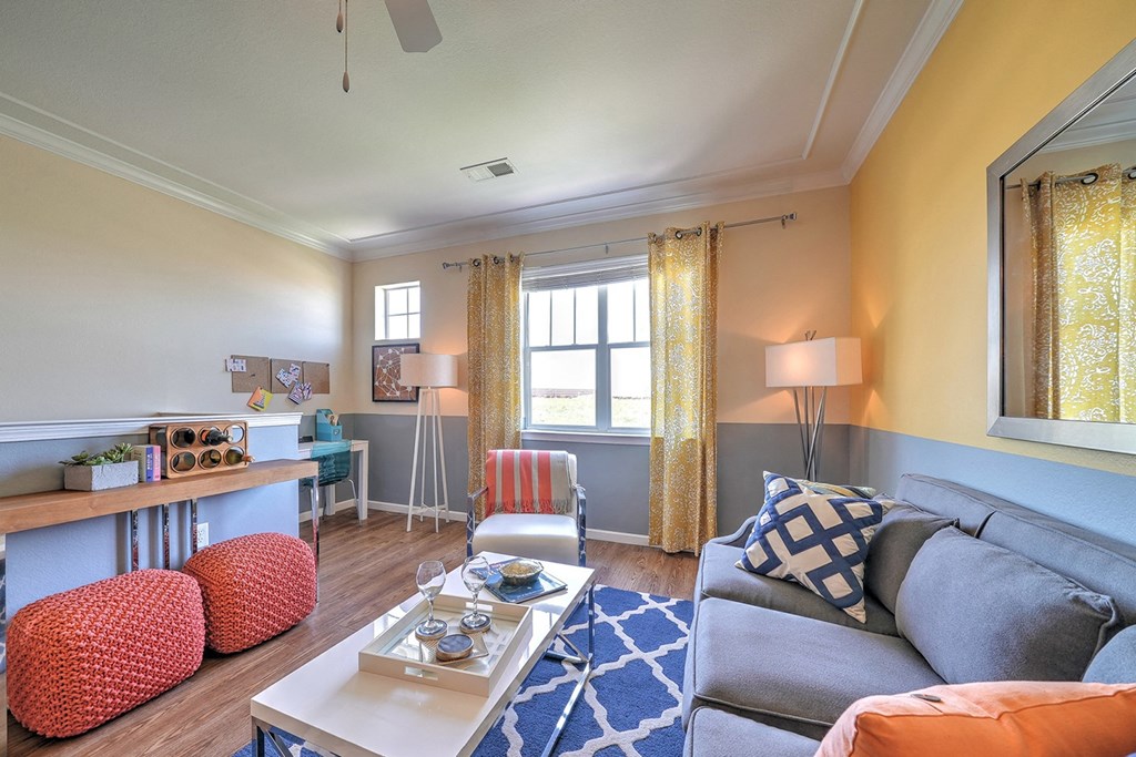 a living room filled with furniture and a large window