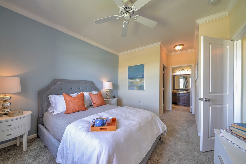 a bedroom with a bed and a ceiling fan