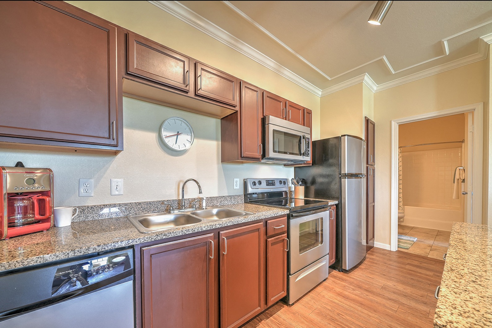 a kitchen with wooden cabinets and granite countertops