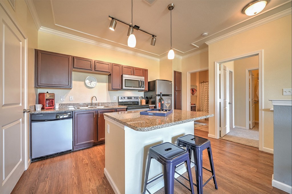 a kitchen with an island and stools