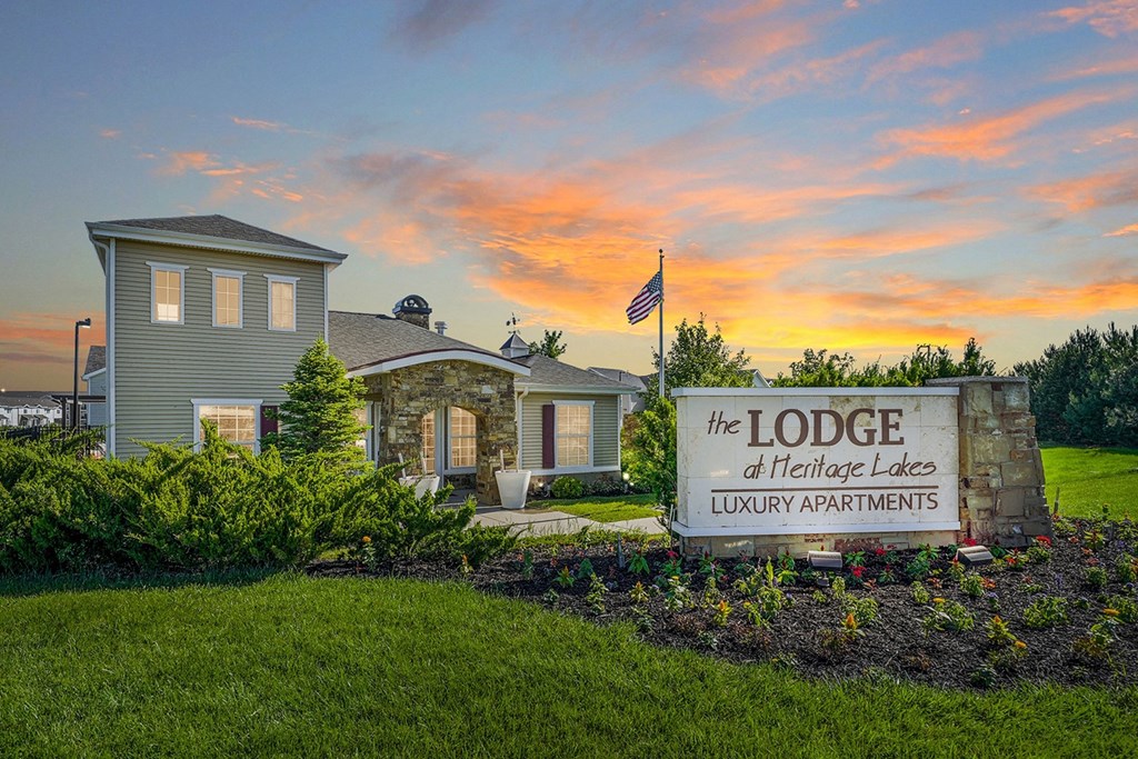 a home with a sign that reads the lodge of heritage lakes