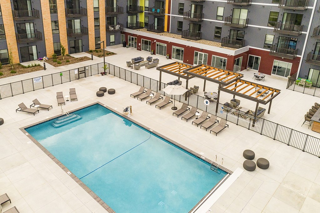 The Sanctuary Deck featuring a resort-style pool, firepit, summer kitchen with outdoor grills, hammocks and bocce ball court at The Nexus at Gray's Landing in Downtown Des Moines, IA