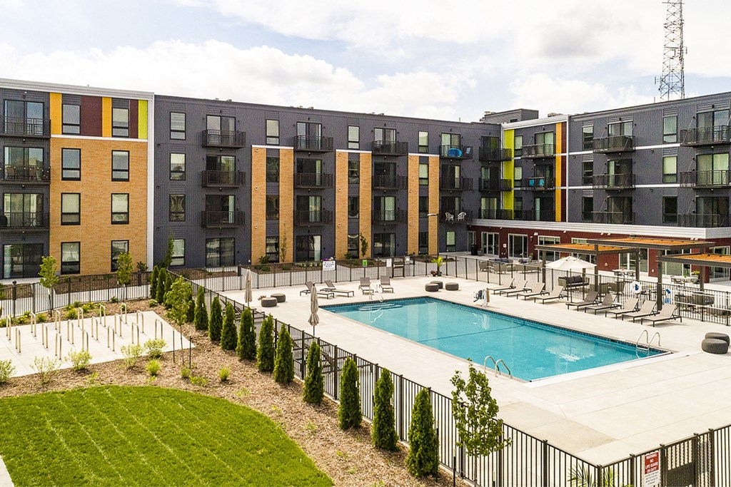 The Sanctuary Deck featuring a resort-style pool, firepit, summer kitchen with outdoor grills, hammocks and bocce ball court at The Nexus at Gray's Landing in Downtown Des Moines, IA
