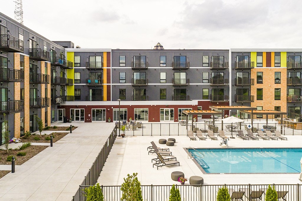 The Sanctuary Deck featuring a resort-style pool, firepit, summer kitchen with outdoor grills, hammocks and bocce ball court at The Nexus at Gray's Landing in Downtown Des Moines, IA