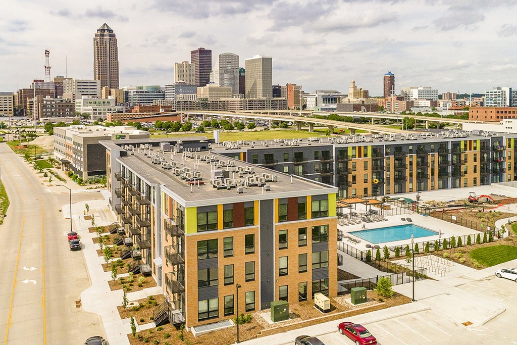 The Sanctuary Deck featuring a resort-style pool, firepit, summer kitchen with outdoor grills, hammocks and bocce ball court at The Nexus at Gray's Landing in Downtown Des Moines, IA