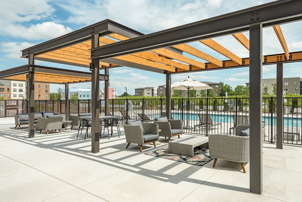 The Sanctuary Deck featuring a resort-style pool, firepit, summer kitchen with outdoor grills, hammocks and bocce ball court at The Nexus at Gray's Landing in Downtown Des Moines, IA