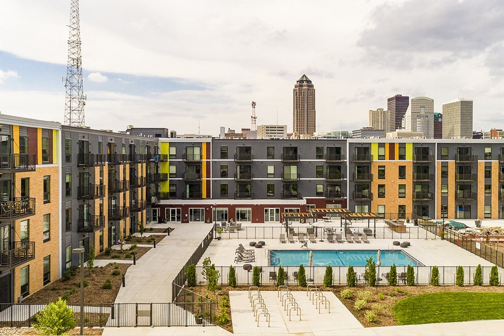 The Sanctuary Deck featuring a resort-style pool, firepit, summer kitchen with outdoor grills, hammocks and bocce ball court at The Nexus at Gray's Landing in Downtown Des Moines, IA