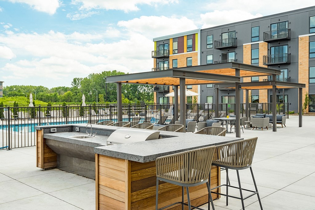 The Sanctuary Deck featuring a resort-style pool, firepit, summer kitchen with outdoor grills, hammocks and bocce ball court at The Nexus at Gray's Landing in Downtown Des Moines, IA