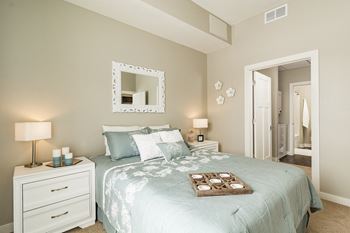 a bedroom with a bed and a mirror
