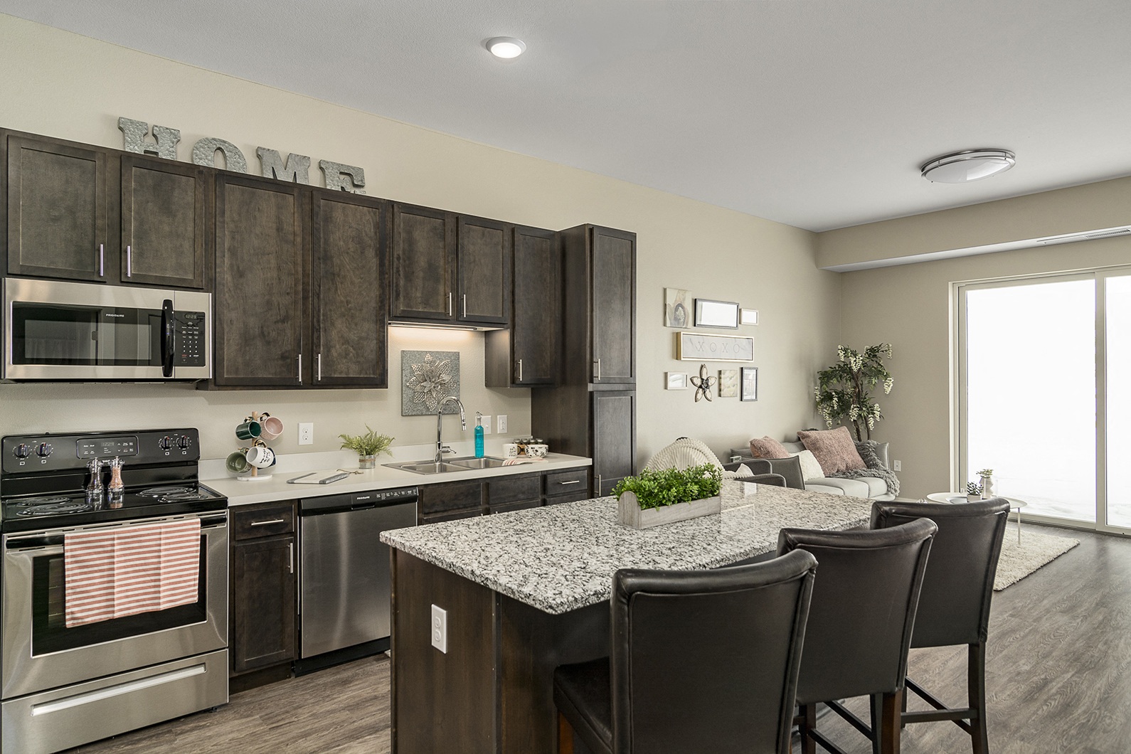 One and two bedroom hi-end apartment homes featuring Energy-Efficient Stainless Steel Appliances,  Granite Kitchen Island, dark cabinets, and much more at The Nexus at Gray's Landing in Downtown Des Moines, IA