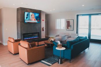 Community clubhouse with fireplace and seating at Northridge Apartments in Gretna, NE