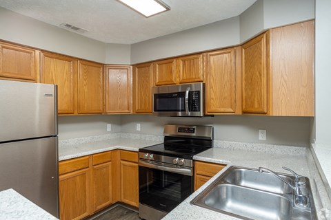 a kitchen with stainless steel appliances and wooden cabinets