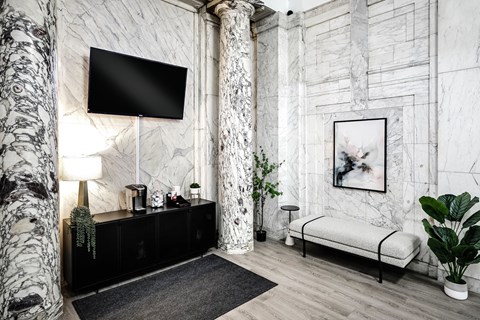 a living room with a television and a bed