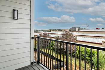 a balcony with a view of a city in the distance