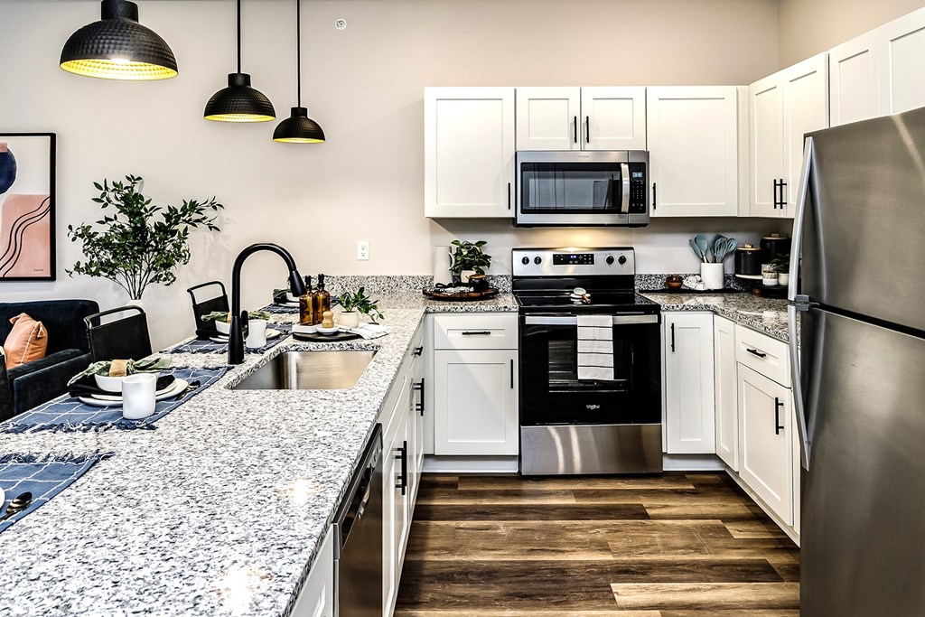 Studio, one and two bedroom apartment homes featuring stainless steel appliances, luxury vinyl floor, granite countertops, large closets and full-size washer and dryer at The Parker in Papillion, NE