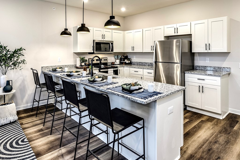 Studio, one and two bedroom apartment homes featuring stainless steel appliances, luxury vinyl floor, granite countertops, large closets and full-size washer and dryer at The Parker in Papillion, NE
